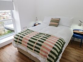 A bedroom with a bed and side tables at Awelfryn
