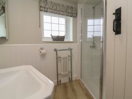 A bathroom with a shower and bathtub at Round Barn in Ilfracombe