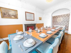 A dining room with a large dining table set at 8 Corkickle Whitehaven