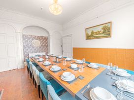 A dining room with a large table set for a meal at 8 Corkickle Whitehaven