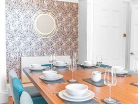 A dining room with a table set for dinner at 8 Corkickle, Whitehaven