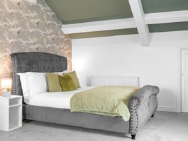 A bedroom with a bed and side table at 8 Corkickle, Whitehaven