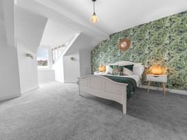 A bedroom with a bed and bedside tables at 8 Corkickle Whitehaven