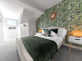 A bedroom with a bed and decorative elements at 8 Corkickle Whitehaven