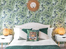 A bedroom with a bed and decorative pillows at 8 Corkickle Whitehaven
