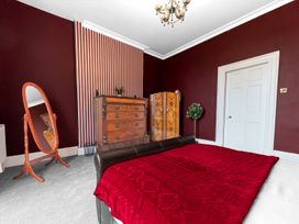 A bedroom with furniture including a bed and chest of drawers at 8 Corkickle, Whitehaven
