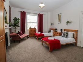 A bedroom with two beds and a sofa at 8 Corkickle Whitehaven