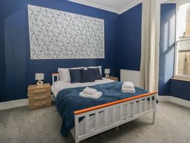 A bedroom with a bed and nightstand at 8 Corkickle Whitehaven
