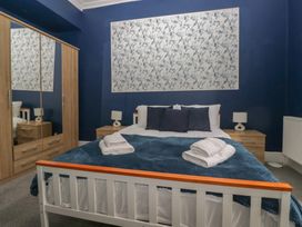 A bedroom with a bed and wardrobe at 8 Corkickle Whitehaven