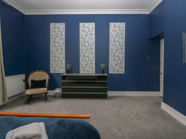 A bedroom with an armchair and dresser at 8 Corkickle Whitehaven