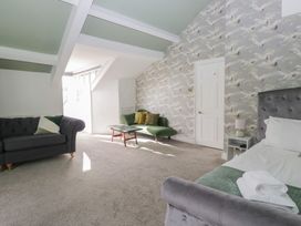 A bedroom with a sofa and coffee table at 8 Corkickle in Whitehaven