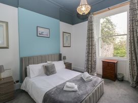 A bedroom with a bed and nightstand at 8 Corkickle in Whitehaven