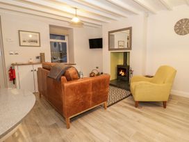 A living room with a sofa and armchair at Riverside Cottage in Conwy