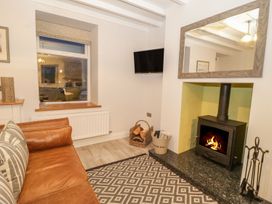 A living room with a fireplace and sofa at Riverside Cottage in Conwy