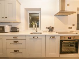 A kitchen with appliances including a microwave and kettle at Riverside Cottage in Conwy