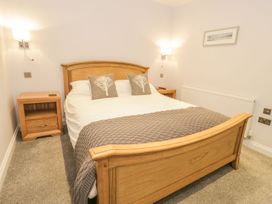 A bedroom with a bed and bedside tables at Riverside Cottage, Conwy