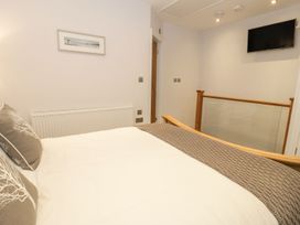 A bedroom with a bed and a television at Riverside Cottage in Conwy
