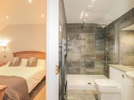 A bathroom with a shower and toilet at Riverside Cottage in Conwy