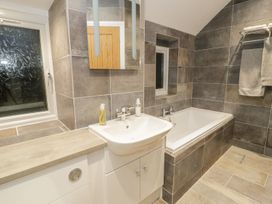 A bathroom with a bathtub and sink at Riverside Cottage in Conwy