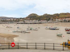 A view of boats on water with hills and houses in the background at Riverside Cottage in Conwy