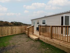An outdoor area with decking and a building at Ellies House in Stranraer