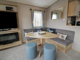A living room with a sofa and table at Ellies House in Stranraer