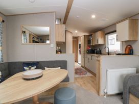 A living room with a table and sofa at Ellies House in Stranraer