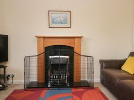 A living room with a fireplace and a television at Castle Terrace in Penrith
