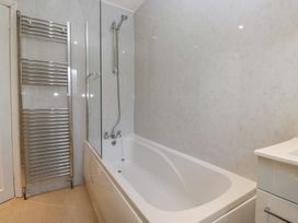 A bathroom featuring a bathtub and shower at Castle Terrace in Penrith