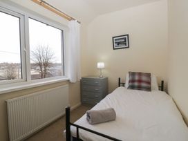 A bedroom with a bed and window at Castle Terrace in Penrith