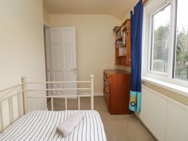 A bedroom with a bed and dresser at Castle Terrace Penrith