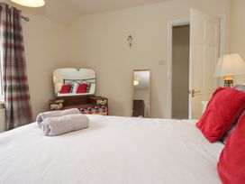 A bedroom with a bed and dresser at Castle Terrace Penrith