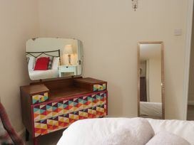 A bedroom with a colorful dresser and mirror at Castle Terrace in Penrith