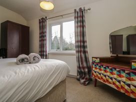 A bedroom with a bed and colorful dressing table at Castle Terrace in Penrith