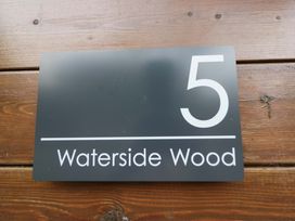 A sign displaying number 5 and the name Waterside Wood