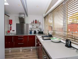 A kitchen with appliances and a countertop at 5 Waterside Wood in Troutbeck Bridge