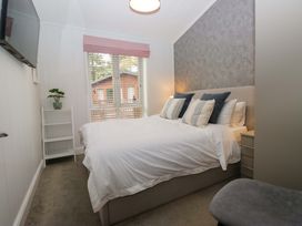 A bedroom with a bed and a television at 5 Waterside Wood Troutbeck Bridge