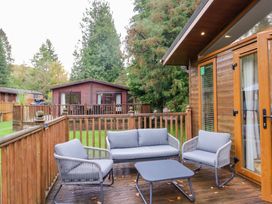 A seating area with a table and chairs at 5 Waterside Wood Troutbeck Bridge