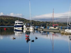 A marina with several boats and ducks at 5 Waterside Wood Troutbeck Bridge