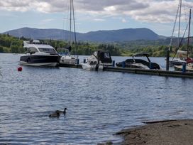 A view of boats in the water with ducks at 5 Waterside Wood Troutbeck Bridge