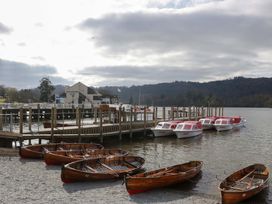 A dock with boats and a building at 5 Waterside Wood Troutbeck Bridge