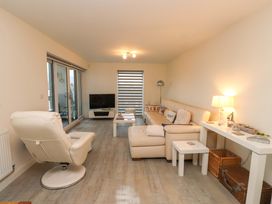 A living room with a sofa and coffee table at Heulfan in Conwy