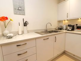 A kitchen with a sink and appliances at Heulfan in Conwy