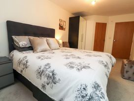 A bedroom with a bed and wardrobe at Heulfan, Conwy