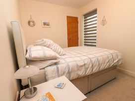 A bedroom with a bed and bedside table at Heulfan in Conwy