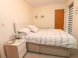 A bedroom with a bed and bedside table at Heulfan in Conwy