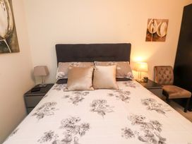 A bedroom with a bed and side tables at Heulfan in Conwy