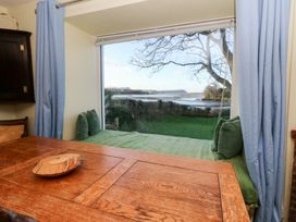 A dining room with a view of the landscape at Bryncyn in Newport, Pembrokeshire