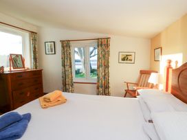 A bedroom with a bed and furniture at Bryncyn in Newport, Pembrokeshire