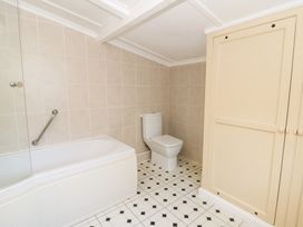 A bathroom with a bathtub, toilet, and sink at Bryncyn, Newport, Pembrokeshire